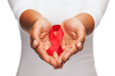 A person holding an AIDS ribbon in cupped hands